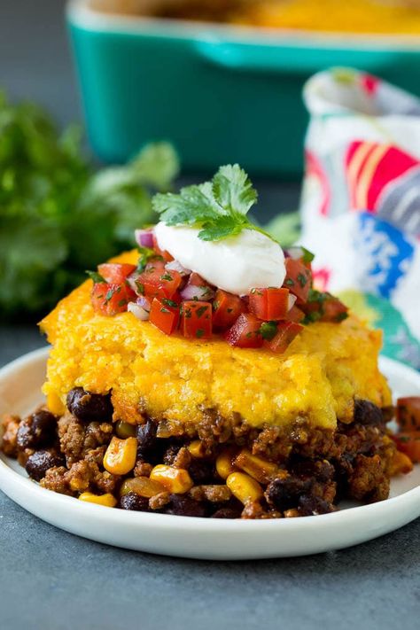 This tamale pie is seasoned ground beef, corn and beans baked together with cheddar cornbread to make a hearty and comforting casserole. Easy Tamale Pie, Cornbread Dishes, Easy Tamales, Beans Baked, Corn And Beans, Tamale Pie Recipe, Cheddar Cornbread, Seasoned Ground Beef, Authentic Mexican Recipes