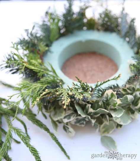 Make this simple DIY Christmas candle wreath for a stunning holiday centerpiece Winter Wedding Wreath Centerpieces, Candle Arrangements Christmas, Candle Ring Centerpiece, Christmas Wreaths For Table, Christmas Table Wreath Centerpiece, Christmas Wreath Centerpiece Wedding, Diy Candle Wreath Rings, Christmas Wreath Table Centerpiece, Christmas Candle Rings Diy