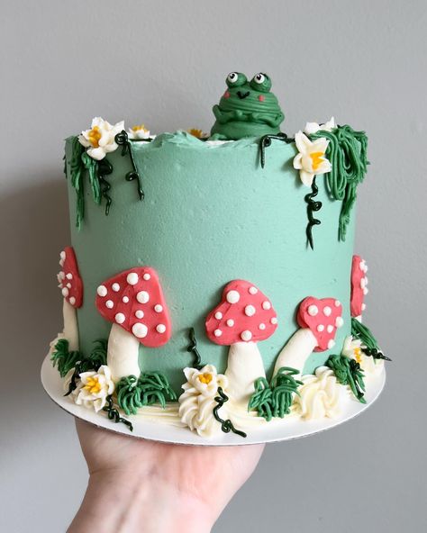 Funky froggy feels 🐸🍄🌿🌼🌾 • • Order sweet swampy cakes on our website 🔗 in bio! • • #frogcake #buttercreamcakes #buttercreamcake #buttercream #buttercreamart #customcake #cakedecorating #cakestagram #cakedesign #instacake #cakeideas #vermontbakery #vermontbaker #homebaker #homebakery #bakergram #vermont #madeinvermont #madeinvt #shelburnevermont #shelburnevt #bluehousebakeshop #cake #baker #pastrychef Buttercream Mushroom Cake, Mushroom Cake Design, Frog Mushroom Cake, Bug Cake Ideas, Character Cake Ideas, Simple Baby Shower Cake Ideas, Decorated Cakes Ideas, Mushroom Cake Ideas, Half Moon Cake