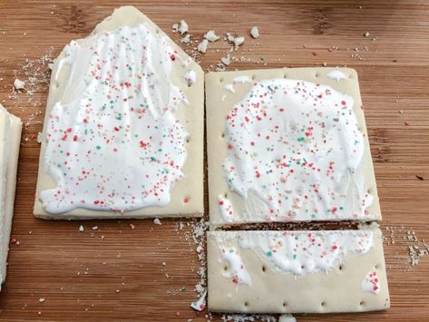 Fun and totally unexpected twist on traditional gingerbread houses these Holiday Houses feature a crowd favorite, Pop Tarts! DIY your gingerbread house this year with these easy step by step instructions. #GingerbreadHouses #Gingerbread #Christmas, #ChristmasDecorating #ChristmasActivity #Holiday #PopTarts #TheDashleys #TheDashleysKitchen #HolidayFood #FestiveTreats #HolidayDIY #GingerbreadDIY #DIY Poptart Houses Christmas, Poptart Gingerbread Houses, Gingerbread House Tutorial, Diy Gingerbread House, Traditional Gingerbread, Ginger Bread House Diy, Diy Gingerbread, House Tutorial, Its Christmas Eve