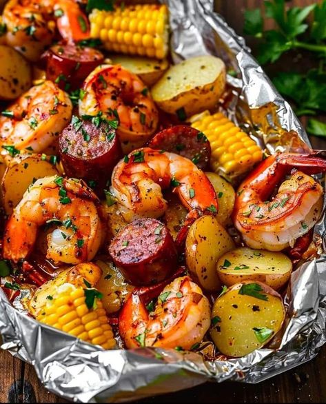 Stanley Tucci Recipes 🍝🍛🌭🍕 | shrimp, corn, potatoes, and smoked sausage with flavorful seasonings, all wrapped up in individual foil packets that are easy to serve and enjoy | Facebook Shrimp Boil On The Grill, Potatoes And Smoked Sausage, Grilled Foil Packets, Shrimp Boil Foil, Foil Packet Potatoes, Shrimp Corn, Chaffle Recipe, Seafood Boil Recipes, Shrimp Sausage