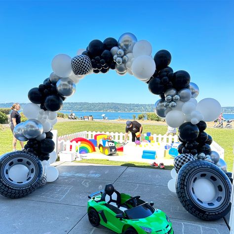 Cars Theme Walkway Arch: Black and White Balloons, Inflatable Tires, and Foil Checkered Accents! 🚗🎈 #CarsTheme #WalkwayArch #InflatableTires #CheckeredBalloons #PartyDecor Race Car Balloon Arch, Walkway Arch, Balloon Entrance, Black And White Balloons, Balloon Business, Balloon Cars, Racing Flag, Balloon Artist, Car Themed Parties