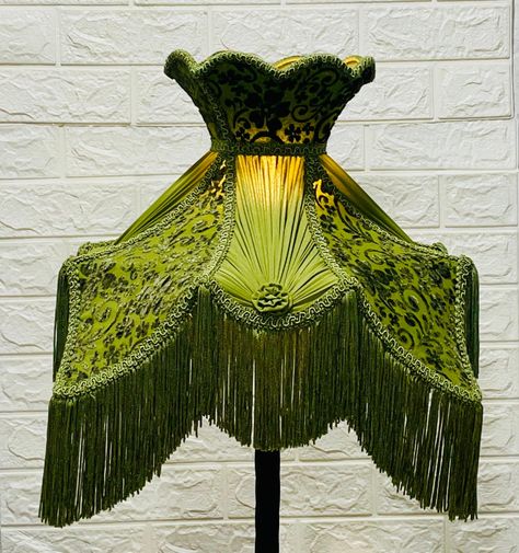 Lampshade lotus green burn-out velvet with fringe. This lampshade is handmade & may have slight imperfections (as you may see) which are inherent to hand-crafted items and should be viewed as part of its natural beauty and charm. They may show subtle variations and small flaws which are part of the individual character and charm of handicraft work. RETURN POLICY: WE DO ACCEPT RETURNS BUT WILL ONLY REFUND THE AMOUNT FOR THE COST OF THE LAMPSHADE. SO, IF YOU HAVE TO RETURN THE LAMPSHADE FOR ANY GENUINE REASON, YOU ARE RESPONSIBLE FOR THE SHIPPING COST. ONCE WE RECEIVE THE LAMPSHADE BACK, IN THE CONDITION THAT IT WAS SENT OUT, WE WILL REFUND THE COST OF THE LAMPSHADE ONLY. Please feel free to ask for any assistance in case of confusion or clarification. Green Lampshade, Velvet Lampshade, Ceiling Lampshade, Green Lamp Shade, Victorian Lamps, Silk Lampshade, Victorian Lampshades, Crystal Chandelier Lighting, I Love Lamp