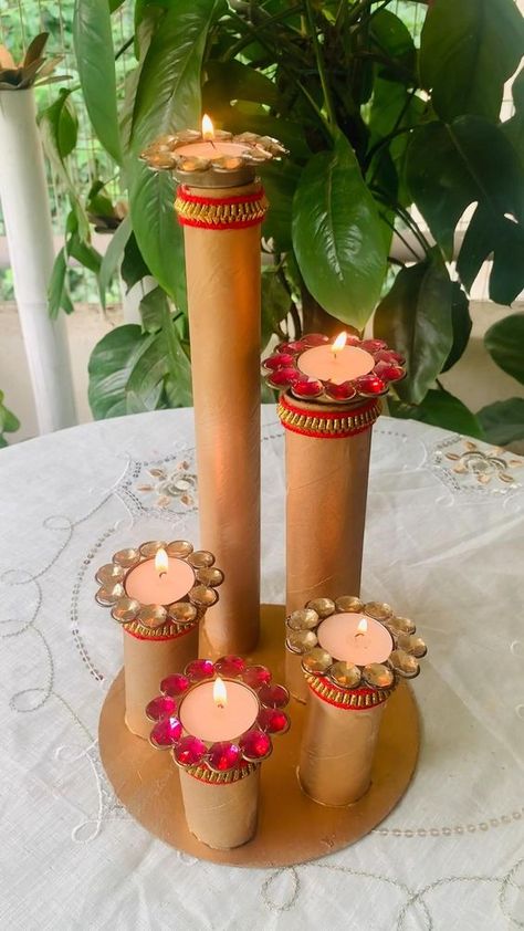 Difficulty: Easy     DIY CANDLE STAND PREPARED BY TOILET PAPER & KITCHEN PAPER CARDBOARD STAND & I have also used cake base cardboard which we get with every cake AS A BASE FOR CANDLE STAND ……..  • :  • 💥U just need golden colour choice is totally yours either u can use spray paint or acrylics…  • 💥I have used lace to give it a festive look….  • :  • :  :  Use it all whatever way u like and your FESTIVE CANDLE STAND IS READY …….  • :  • :  • So why are you waiting , let’s start getting ready for festivities …..  • :  • :  • 📌IF U LIKE THE IDEA SHARE AND SAVE IT FOR REFERENCE   • AND STAY TUNED FOR MORE FESTIVE DIY WITH ME @magic_of_green Candle Stand Diy, Cardboard Stand, Diwali Activities, Paper Kitchen, Janmashtami Decoration, Cake Base, Diwali Decorations At Home, Diwali Decoration Items, Diy Diwali Decorations