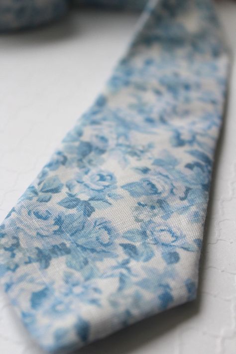 I hand stitched this particular neck tie from a sweet sweet dusty blue floral cotton, boarding on linen but thinner. I lined it a bit to give it some extra weight ; )   I love this fabric find and only have enough for about 12 ties in total so don't miss out on these charming pieces. This tie measures 59" in length and 2.5" at the widest point ( slightly narrower than standard width ) Did you know...  Handsome&Lace isn't an assembly line production company, nor do I scrimp on adding small detail Light Blue Floral Tie, Blue Wedding Ties, Light Blue Groomsmen Suits, Dusty Blue Groomsmen Attire, Dusty Blue Tie, Blue Floral Tie, Blue Groomsmen, Groomsmen Tie, Invisible Stitch