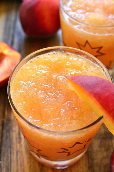 This Frozen Peach Slush is a delicious blend of citrus, peach tea, peach schnapps, and brandy...topped off with your favorite sparkling soda! Perfect for parties, special occasions, or lazy summer days. The perfect drink for summer! Slush Alcohol Drinks, Peach Slush, Peach Schnapps Drinks, Alcoholic Slush, Brandy Slush, Drink For Summer, Slush Recipes, Peach Drinks, Lazy Summer Days