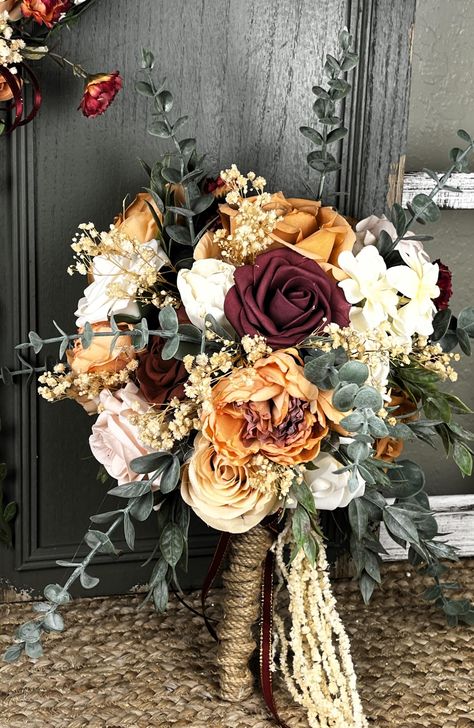 This beautiful bride bouquet is just the perfect blend of peach blush and ivory flowers to give it that soft and romantic fall Victorian feel.  Made with a real touch/look, it has faux flowers, wood sola flowers, dried flowers, pampas grass, and faux greenery.   Bleached wisteria vines hang at the bottom.    The stem is wrapped with thick jute twine.  The bouquet is a single-sided bouquet measuring 15" tall from tip to tip and 10" wide.  The matching headband is a standard adult sized adjustable Muted Fall Wedding Flowers, Fall Bride Bouquets, Fall Wedding Flowers September, Fall Rose Bouquet, Western Wedding Bouquets, Wedding Flower Bouquets Bridal, Southern Wedding Flowers, Fall Bridal Bouquet October, Flower Bride Bouquet