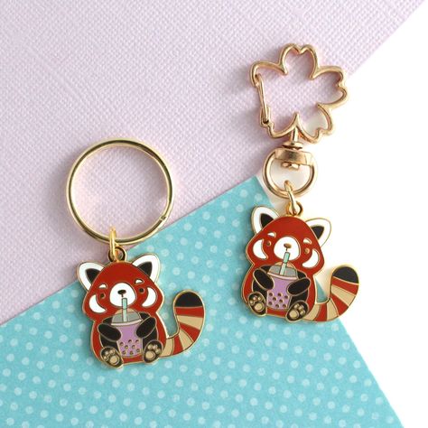 Show off your love for bubble tea and red pandas with this cute enamel keychain! Attach it to your keys or purse and take your little red panda companion with you everywhere you go. Be the envy of all the boba-lovers with this fun and adorable accessory! Details: This listing is for one keychain 1" (25mm) tall and 1" (25mm) wide and 1.4mm thick hard enamel charm Gold plated Comes with a 24mm key ring or a sakura swivel key ring "Wild Whimsy Woolies" backstamp Packaged on a backing card ~~~~~~~©2023 Wild Whimsy Woolies Panda Drinking Boba, Panda Ring, Panda Jewelry, Enamel Keychain, Panda Gifts, Red Pandas, Panda Love, Backing Card, Boba Tea