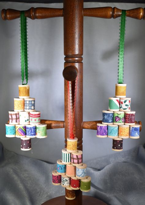 "Spool Tree Christmas Ornament to adorn you tree or tie on a package for an added treat.  Spools are covered in various fabrics with a brown fabric trunk and gold fabric spool for the star on top.  A great little addition to your tree.  Price is per ornament.  Spools are covered in a variety of fabrics as shown in pictures.  We will choose for you as there really isn't a way to individually mark them.  Tree is approximately 2.5\" tall and 3.75\" wide.  Hanger is approximately 3.5\" long. Orders are processed in 2 - 3 business days although we do our best to ship as quickly as possible.  All items listed are completed items." Wooden Spool Crafts, Christmas Orniments, Winter Diy Crafts, Spool Crafts, Diy Christmas Ornaments Easy, Quilted Christmas Ornaments, Fun Christmas Crafts, Christmas Tree Crafts, Wooden Spools