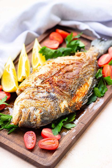 How to fry a whole fish on the stove or deep fried perfectly is here! Get flaky flesh and crispy fish skin seasoned or battered. Whole Sea Bass Recipes, Whole Fish Fry Recipe, Fried Tilapia Recipes, Fried Whole Fish, Oven Fried Fish, Fish Fry Recipe, Sea Bass Recipes, Deep Fried Fish, Fried Tilapia