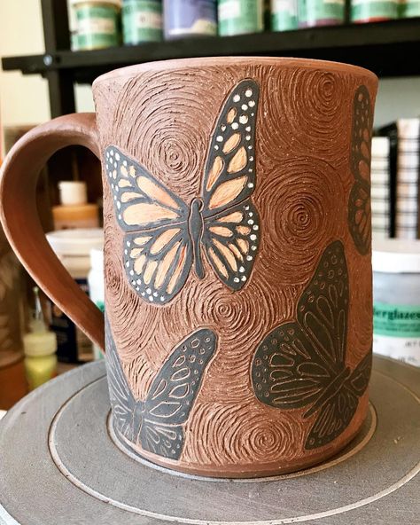 Debbie Griffith on Instagram: “It’s 10 degrees and the carving continues. Hands don’t fail me now! Almost finished! ❄️🦋☕️#wip#sgraffito#butterfly #monarch…” Butterfly Pottery Ideas, Butterfly Ceramics Ideas, Sgraffito Mug, Ceramics Projects Ideas, Sgraffito Plates, Sgrafitto Ceramics, Butterfly Pottery, Ceramic Sgraffito, Sgraffito Designs