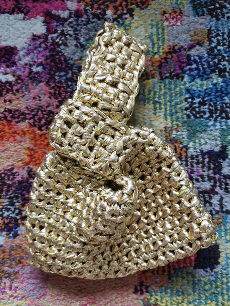 Japanese Knot Style Bag is Crocheted with a beautiful textured stitch made with Gold Metallic yarn.  Its unique crochet pattern adds vintage charm to any outfit, making it a versatile accessory for both casual and formal occasions.  Great gift idea for all ages. It will hold your cell phone, Credit cards, Lipstick, Chapstick, Sunglasses, change, etc.. Perfect for Festive Parties, Evenings out, Weddings, Honeymoon, ... all of your adventures and trips.   The finished Crochet Japanese Knot Pouch s Metallic Crochet Bag, Knot Crochet Bag, Mosu Bag, Crochet Evening Bag, Knot Purse, Mini Bag Crochet, Mini Bag Pattern, Crochet Japanese, Crochet Phone Bag