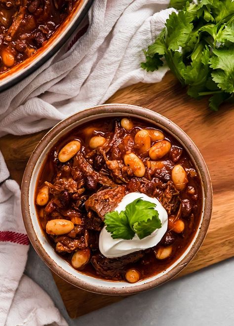 Beer Braised Short Rib Chili - This recipe is so easy and so delicious! Use your Dutch oven for a tender beer braised beef short rib. Add beans at the end or keep it beanless and just enjoy the short rib with the beer and chili flavor. Use your favorite beer or try our favorite - a stout! Simple enough to make for a crowd or a casual family dinner. Serve with homemade cornbread for a perfect chilly weeknight dinner. Short Ribs Chili Recipe, Short Rib Chili, Beer Braised Short Ribs, Beer Braised Beef, Chili Food, Lunch Restaurant, Homemade Cornbread, Braised Short Ribs, Short Rib