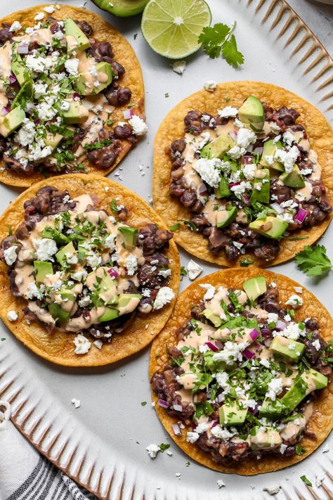 Black Bean Tostadas - Dishing Out Health Vegetarian Tostadas, Bean Tostada, Dynamite Sauce, Black Bean Tostadas, Traditional Refried Beans, Bean Tostadas, Vegetarian Tacos Recipes, Tostada Recipes, Cucumber Avocado Salad