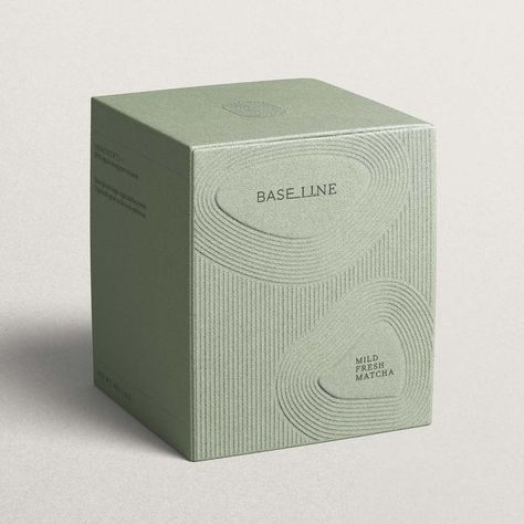 A cardboard soft green tea box with an embossed line pattern inspired by Kyoto gardens. It features the company, Baseline, logo and product description inside a pebble shape. Matcha Packaging, Mises En Page Design Graphique, Visuell Identitet, Luxury Packaging Design, Skincare Branding, Cosmetic Packaging Design, Skincare Packaging, Candle Packaging, Box Packaging Design