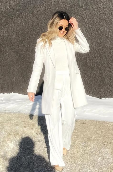 17+ Chic Winter White Outfits to Dazzle in the Cold - TheChicSavvy How To Style White Suit Women, Winter White Cocktail Outfit, White Winter Party Outfit, White In Winter Outfits, All White Winter Outfit Classy, Winter White Pants Outfit Dressy, Jumpsuit Outfit With Cardigan, Winter White Pants Outfit, Winter White Outfits For Women