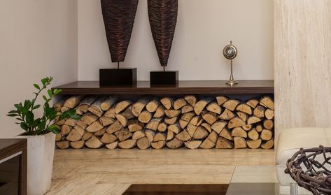 Underneath the buffet or console table? Great idea for firewood storage. Log Store Indoor, Indoor Log Storage, Indoor Firewood Rack, Firewood Storage Indoor, Wood Storage Rack, Wood Store, Firewood Rack, Firewood Storage, Trendy Living Rooms