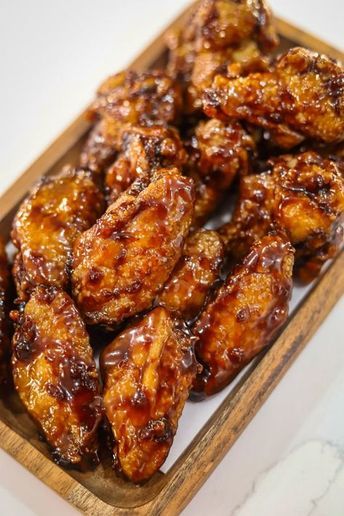 Sticky Honey Garlic Wings are irresistibly delicious and perfect for satisfying your wing cravings! These chicken wings can be fried, oven baked or air fried until golden and crispy, then tossed in a sweet-sticky honey garlic sauce. Serve as an easy to make dinner or appetizer for a deliciously satisfying treat. Honey Garlic Wings, Oven Chicken Wings, Chicken Wing Recipes Fried, Honey Chicken Wings, Sticky Chicken Wings, Air Fry Chicken Wings, Honey Garlic Chicken Wings, Garlic Wings, Garlic Chicken Wings