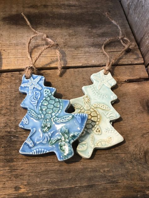 "SEA TURTLE ORNAMENT - Sea turtles are swimming all over this tree ornament! A mix of the beach and Christmas - my two favorites! 🌲🐢 - Approx 5\" tall - Non toxic/Lead Free  - Jute hanger - Back is unglazed - Other color options available upon request *handmade pottery- may vary slightly from photo. Pattern of turtles will vary as well" Pottery Tree Ornaments, Chrismas Crafts, Sea Turtle Decor, Beach Christmas Trees, Pottery Christmas, Turtle Ornament, Ceramic Christmas Decorations, Pottery Ornaments, Wool Appliqué