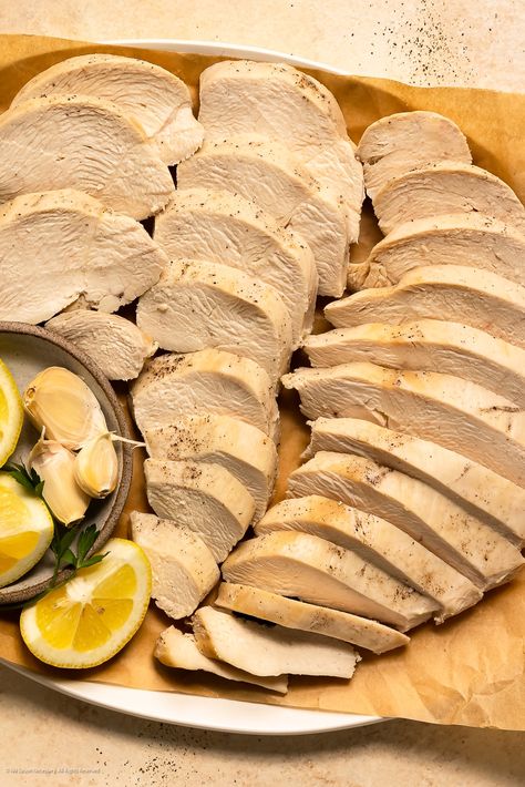 Overhead photo of thinly sliced chicken breasts poached, thinly sliced, and arranged on a serving platter. Sliced Chicken Deli Meat Recipes, Baked Thinly Sliced Chicken Breast, Poaching Chicken, Schecks Honey Lemon Chicken, Sliced Chicken Breast Recipes, How To Poach Chicken, Poach Chicken, Scheck Eats Honey Lemon Chicken, Fancy Kitchen