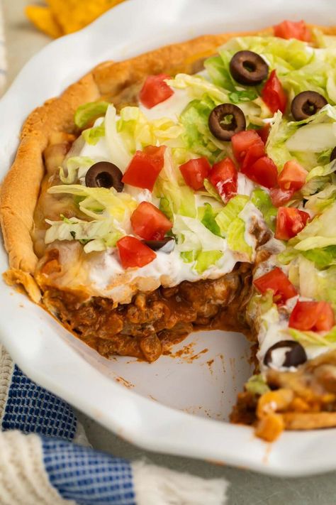 Mix up your next taco night with this delicious, easy taco pie recipe. It's loaded with ground beef, onion, bell pepper, salsa, refried beans, corn, and taco seasoning, all topped with shredded cheese and baked in a savory pie crust. This taco pie is going to be a new family favorite dinner! Taco Pie With Bisquick, Bell Pepper Salsa, Easy Taco Pie, Mexican Pie, Savory Pie Crust, Enchilada Pie, Taco Pie Recipes, Pie Crust Top, Chili Pie