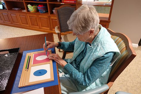 Senior lady using Montessori metal insets to maintain fine motor and writing skills at nursing home. Book Discussion, Montessori Classroom, Memory Care, Montessori Materials, Leadership Roles, Teacher Guides, Montessori Activities, Teacher Classroom, Quality Of Life