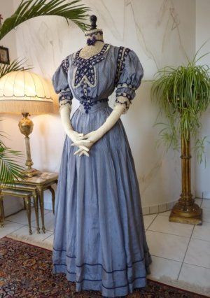 Extraordinary Reception Gown, ca. 1901..Navy and white pin stripe paper silk reception gown, ca. 1901. Bodice with puffed short sleeves. Lace and dark lavender/navy blue silk soutache trims. Rich decorated with two kind of laces. Matching belt. 1900s Dress, Edwardian Gowns, 1900 Fashion, 1900s Fashion, 1910s Fashion, Reception Gown, Edwardian Dress, 20th Century Fashion, Victorian Clothing