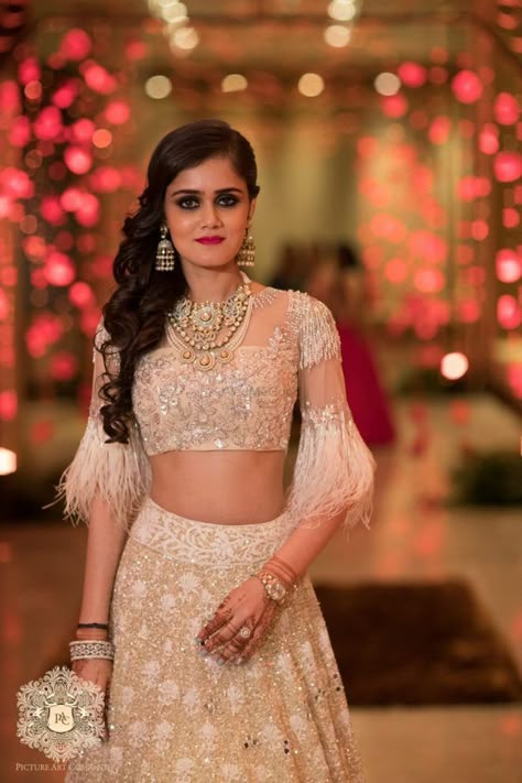 How To Nail Winter Weddings While Looking Fashionable At The Same Time! | WedMeGood Feather Blouse, Lehenga Jewellery, Pink Lehenga, Unique Blouse, Trendy Blouses, Trendy Blouse Designs, Bridal Look, Feather Dress, Indian Designer Wear