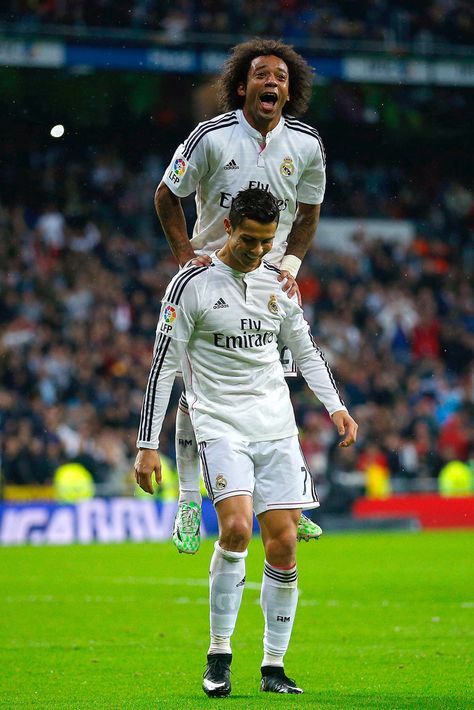 Cristiano Ronaldo of Real Madrid CF celebrates scoring their fifth goal with teammate Marcelo jumpig over him during the La Liga match between Real Madrid CF and Rayo Vallecano de Madrid at Estadio Santiago Bernabeu on November 8, 2014 in Madrid, Spain. Ronaldo And Marcelo Wallpaper, Ronaldo And Marcelo, Cr7 Goals, Benzema Real Madrid, Cr 7, Ronaldo Photos, Real Madrid Team, Ronaldo Real Madrid, Ronaldo Real