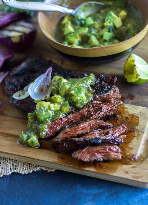 Delicious tender grilled skirt steak slathered with a red chile marinade that creates a mouth-watering crust. Topped with a bright tomatillo avocado salsa. Tomatillo Avocado Salsa, Skirt Steak Fajitas, Tomatillo Recipes, Skirt Steak Marinade, Skirt Steak Recipes, Grilled Skirt Steak, Cucumber Salsa, Bbq Shrimp, Steak Marinade