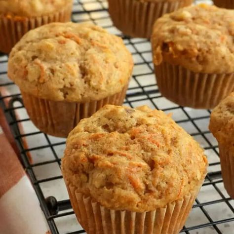 These moist Carrot Muffins bake up perfectly every time with plenty of freshly grated carrots, pineapple, and walnuts. They are tall bakery-style muffins packed with flavor and just the right balance of spice from cinnamon and ginger. Bake a fresh batch today and freeze half for a quick on-the-go breakfast or snack in the weeks ahead.These are sky-high Bakery style Carrot Muffins dotted with shredded carrots, crushed pineapple, and walnuts and spiced with ground cinnamon and ground ginger. Carrot Cake Muffin Recipe, Freeze Muffins, Carrot Muffin Recipe, Ginger Muffins, Bakery Style Muffins, Carrot Cake Muffins, Carrot Muffins, Banana Muffin Recipe, Shredded Carrots