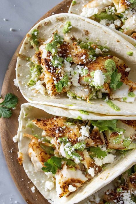 Cod Fish Tacos with Cabbage Slaw made with garlic-lime cilantro sauce, cabbage, and cotija cheese. Easy to make and whips up in 30 minutes. Cod Fish Tacos, Easy Fish Taco Recipe, Fish Tacos With Cabbage, Easy Chicken Fajitas, Cilantro Lime Slaw, Brisket Tacos, Best Enchiladas, Easy Fish Tacos, Cilantro Lime Sauce