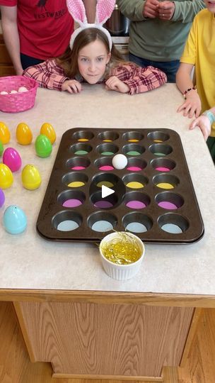 The Muffin Tin Easter Game 🧁 | The Muffin Tin Easter Game 🧁  Family plays fun Easter holiday muffin tin game by bouncing ping pong balls for prizes. Whoever gets a ball in the golden... | By Benson Bros | Alright. Go for it Aaron. Bounce it. Oh. Oh you got this one. Nice. Which means you get a yellow egg. I'm going to go right here. Right there. See what it is. What's your prize? Oh. Oh. A dollar. 1. 1. Bounce it. Your turn. Oh. You got a pink one which means you get a pink egg. It's going to go right here. What's your prize? Your turn dad and before you go, if you make it here, you get the golden egg which has a special prize. Alright. Alright, go for it. Oh, that was so close. Good try. Go for it, Paul. Go for it. Oh. Oh, you get a purple one. Purple. Okay. Alright. Right here. Right h Benson Bros, Party Game Prizes, Easter Resurrection, Egg Game, Redecorating Ideas, Egg Crates, Easter Games, Game Prizes, Ping Pong Balls