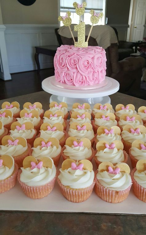 Minnie mouse cake and cupcakes pink and gold Minnie Mouse Cupcakes Pink And Gold, Minnie Gold And Pink Birthday, Minnie Mouse Gold And Pink Party, Pink And Gold Minnie Mouse Party Ideas, Pink And Gold Minnie Mouse Centerpieces, Minnie Mouse Cake And Cupcakes, Minnie Mouse First Birthday Party, Pink And Gold Minnie Mouse Party, Minnie Mouse Smash Cake