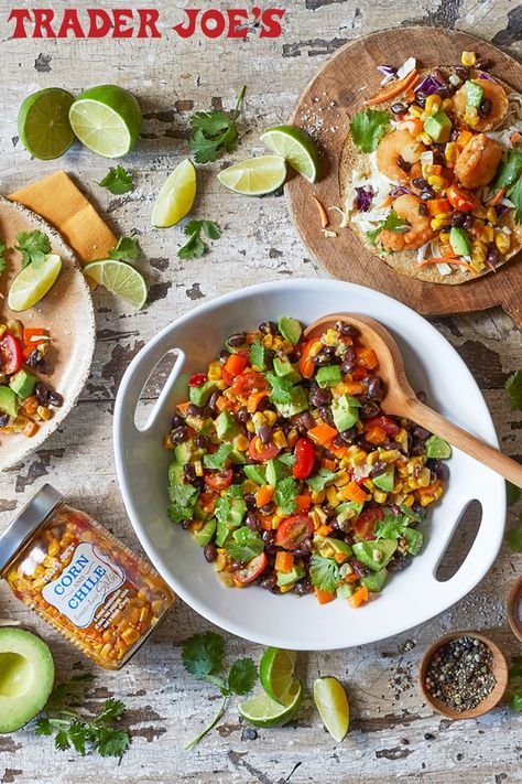 A bowl of Corn Salsa Salad made with Trader Joe's Corn & Chile Tomato-less Salsa, black beans, tomatoes, avocados, and cilantro sits next to a taco made with the Corn Salsa Salad and shrimp and an unopened jar of the salsa. Trader Joes Corn Salsa, Corn Salsa Salad, Easy Corn Salsa, Easy Corn Salad, Corn Chip, Salsa Salad, Corn Salsa Recipe, Chile Recipes, Tacos Burritos