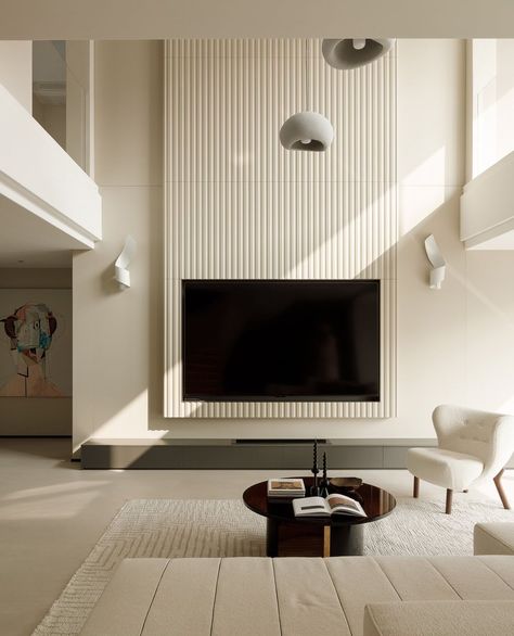 In interior design, curved lines can introduce a sense of softness, flow, and movement to a space. They also create contrast with the sharp angles of straight forms and geometric shapes. In this space, the white of the curved staircase is complemented by the soft lines, creating a seamless transition between levels and giving the space a softer appearance. The tall TV wall balances the overall rhythm of the space. The majority of the furniture features warm colours such as coffee and grey,... Curved Tv Wall, Dwelling Place, Curved Tvs, Warm Colours, Curved Staircase, Two Story Homes, Curved Lines, Real Estate Development, Straight Lines