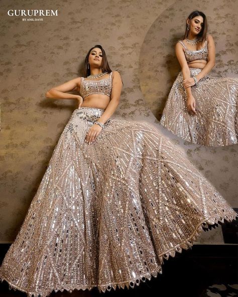 "Step into a world of ethereal beauty with this stunning silver shiny lehenga choli, a true testament to the artistry of ethnic fashion. The lehenga, adorned with exquisite embroidery, captures the light with its luminous sheen, creating a mesmerizing effect that is nothing short of magical. Each delicate stitch and intricate pattern is crafted with precision, reflecting a perfect blend of tradition and contemporary wear. Email : guruprem.socialmediateam@gmail.com Contact Us : +91 816978764... Shiny Lehenga, Geometric Lehenga, Champagne Lehenga, Mirror Lehenga, Champagne Mirror, Global Wedding, Tamil Brides, Global Dress, Embellished Blouse