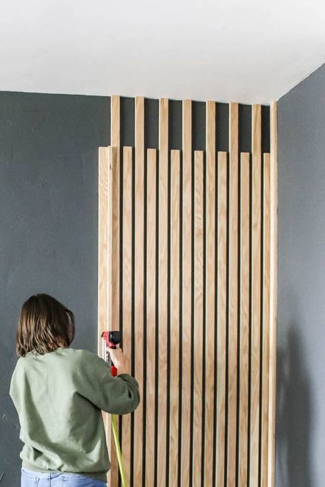 Have you seen the DIY slat wall trend yet? Instagrammers and bloggers everywhere are adding wood slats to their walls and it creates such a modern and fun look. I love that, unlike the shiplap trend that is usually painted, people are letting those natural wood tones shine through! Wooden Slat Wall Living Room, Vertical Wood Slat Wall, Modern Wood Accent Wall, Diy Slat Wall, Tv Walls, Wall Trends, Wood Wall Design, Accent Wall Designs, Wood Slat Wall