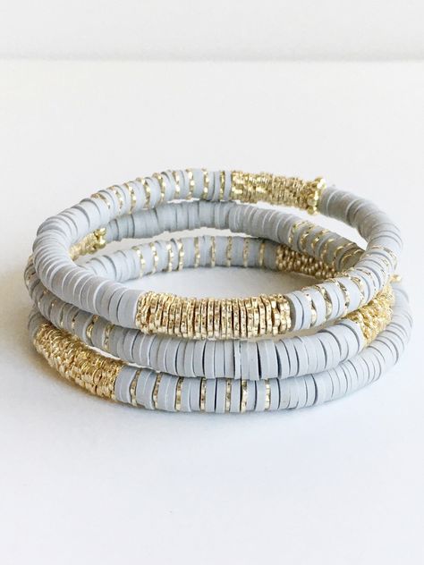 Light Gray Confetti and Gold Beaded Bracelet ⟡ all items are designed and handcrafted in our studio ⟡ Hand strung vinyl and 14kt gold plated beads on stretch material. Fun, lightweight, colorful bracelets - perfect for year round. A combination of polymer clay vinyl beads and 14kt gold plated beads. Each bracelet is stretchable and easily layers with other bracelets or a watch. The bracelet cannot be opened, and need to fit over your hand. Treat yourself to a fun new bracelet! These bracelets ar Polymer Clay Beaded Bracelet, Clay Beads Jewelry Making Tools, Clay Bead Patterns Bracelet, Clay Bead Bracelet Ideas Adults, Gray Clay Bead Bracelet, Clay Bead Bracelet Ideas Neutral Colors, Heishi Jewelry Ideas, Trendy Bracelets 2024, Hieshi Clay Bracelets