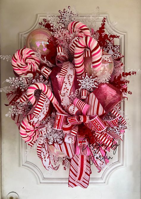 A 20" evergreen wreath shaped in an oval and decorated in red, white and pink accented with designer ribbons, ornaments, and candies. These CANNOT be put between your storm door and regular door.  While I try my best to ensure I use the highest quality of florals that are best for outdoors, it's best to keep your wreath where it is protected from the elements. In due time some colors will fade and that is just due to the elements taking its effect on the wreath.  This wreath is ready to ship and Christmas Bulb Wreaths, Red Christmas Wreaths, Unusual Christmas Wreaths, Christmas Door Design, Diy Christmas Candy, Red Christmas Wreath, Christmas Swag, Whimsical Wreaths, Candy Cane Wreath