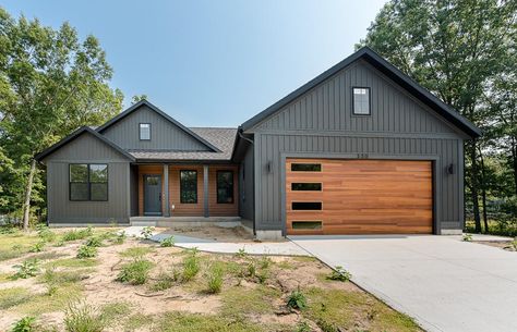 Dark Exterior Siding Ideas, Green House Wood Garage Door, Wood Looking Garage Doors, Dark Gray House Exterior, Grey Siding House, Dark Grey Houses, Unique Garage Doors, Exterior Updates, Exterior House Siding