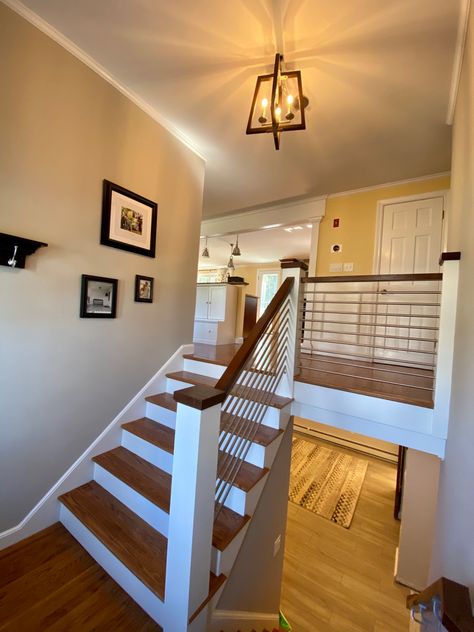 Stairs, railing and balusters replaced in this 1960s split level ranch to update the entryway. Walnut wood and stainless steel. Split Foyer Stairs Remodel, Split Level Railing Ideas Entryway, Railings For Split Level Home, Front Porch Design Split Level, Split Level Entryway Stairs, Split Level Entryway Railing, Staircase Makeover Split Level, Split Level Stairs Remodel Entryway, Split Home Entry Way