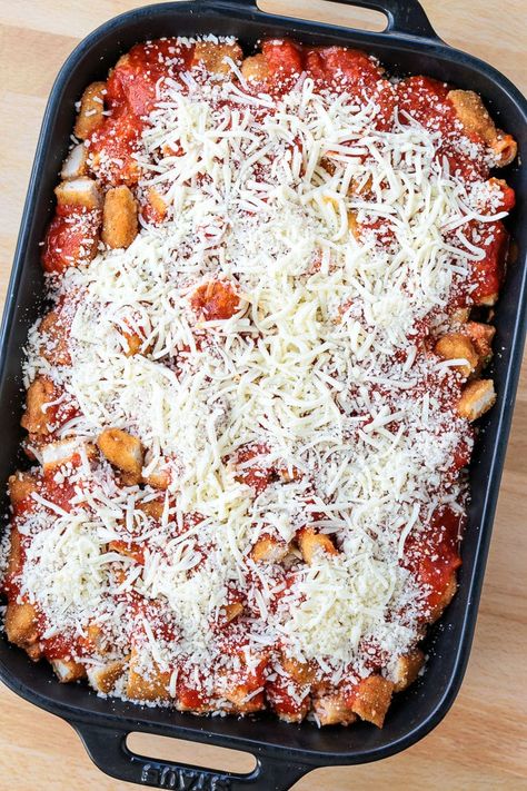 This Chicken Parmesan Casserole uses a fun ingredient that I guarantee is already in your freezer. A comforting, super hearty pasta dish that feeds a crowd, making it perfect for holidays and parties. Chicken Parmesan For A Crowd Parties, Easy Chicken Parm Casserole, Chicken Parmesan For A Crowd, Chicken Parm Casserole, Casserole For A Crowd, Chicken Parmesan Sandwich, Parmesan Pizza, Parmesan Casserole, Chicken Crust Pizza