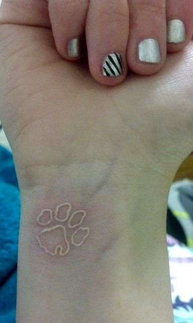 47 Tiny Paw Print Tattoos For Cat And Dog Lovers | Revelist Tattoo Paw Print, Tattoo Paw, Cat Paw Tattoos, Tiny Paw Print, Pawprint Tattoo, Dog Paw Tattoo, White Ink Tattoo, Paw Tattoo, Tattoo Zeichnungen