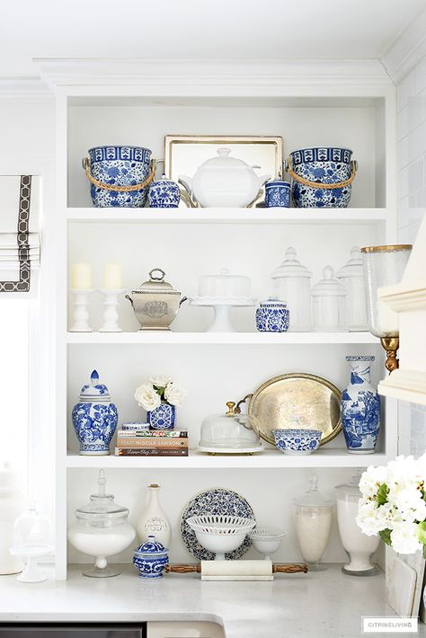 Spring kitchen decorating featuring gorgeous shelf styling using blue and white pieces mixed with cook books, apothecary jars, cake stand and silver pieces. Blue And White Ceramic Decor, Blue And White Mantle Decor, Blue And Silver Kitchen, Blue Kitchen Decor Ideas, Blue And White Kitchen Decor, Shelf Decor Ideas, Blue And White Home Decor, Spring Kitchen Decor, Blue And White Decor