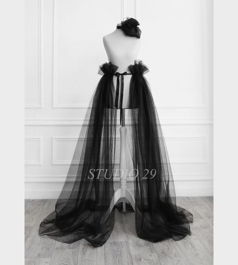 ✨ Gothic black detachable ruffle sheer overskirt with train that you This dramatic open front tulle overskirt with satin bow tie is a gorgeous addition to make a short dress more formal or to add volume and drama to a long dress and feel amazing in your special day💞 ✨ This Victorian steampunk style overlay skirt is transparent, made of two tulle layers and sewn on a satin ribbon. You can tie it back, front or side. #blacktulleskirt #tulleoverskirt #openfrontskirt #gothicbride #bridesmaidsskirt Detachable Wedding Skirt, Open Front Skirt, Photo Shoot Birthday, Fairy Tail Wedding, Tulle Overskirt, Tulle Wedding Skirt, Skirt Tulle, Tulle Skirt Black, Wedding Skirt