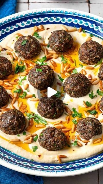 Suzy- Mediterranean Food & Diet on Instagram: "Meatballs & Hummus 😋Recipe👇  Have you ever thought of trying baked meatballs over hummus?   Most people think spaghetti and meatballs, but if you’re up for something new and best level delicious, MAKE THIS easy dinner!   You’ll love the Middle Eastern seasoning in these meatballs! it’s basically what I use for my kofteh kebabs-allspice, cardamom, paprika, sumac, onions, garlic, parsley! Yes, these kofta meatballs are a flavor party!!🎊   Serve them over creamy dreamy hummus with a drizzle of good olive oil and some pita bread and watch how quickly people eat it!   Sure, this can make the perfect mezzo or appetizer, but in my house, this is the perfect protein packed meal / dinner! No one is ever mad when I make this easy Lebanese style recip Lebanese Appetizers Parties, Lebanese Dinner Party, Suzy Mediterranean, Middle Eastern Meatballs, Herb Couscous, Hummus Cup, Kofta Meatballs, Turkish Meatballs, Mediterranean Meatballs