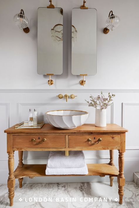 Having taken her cue from a French sideboard she found in an antiques shop, interiors blogger Phoebe Miller sought the perfect basin to sit on top. The delicate design of the Angelica basin tied in beautifully with the bath and light fittings to transform the bathroom into a tranquil oasis. Read our blog for design inspiration. Side Table Bathroom Vanity, Italian Toilet Design, Bathroom Basins Ideas, Turn Of The Century Bathroom, Antique Dresser Bathroom Vanity, Sink Ideas Bathroom, French Bathroom Decor Vintage, Parisian Style Bathroom, Italian Bathrooms