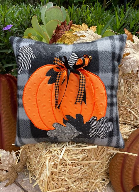 Celebrate the season with this beautiful fleece 16"x16" poly-fil stuffed pillow.   Cuddle fabric was used to create the bright, bold and dimpled pumpkin.  Various black, gray and black/white strip leaves were scattered around to add to the fall feel of this adorable pillow.  Pumpkin and leaves have appliqued and straight stitched details.  Fun ribbon was used to add that extra pop of color. Hand stuffed and hand sewn closed.  An original design. Great gift idea for that person who loves unique, Fall Embroidered Pillows, Fall Pillow Ideas, Halloween Cushions, Halloween Pillows Diy, Throw Pillow Ideas, Pillow Pumpkin, Homemade Pillows, Fall Sewing Projects, Seasonal Pillows