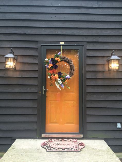 Orange Front Door Black House, Orange Front Door, White Houses With Black Trim, Dark Grey Siding, Black Modern Farmhouse, Orange Front Doors, Grey Siding, Orange Door, Weatherboard House